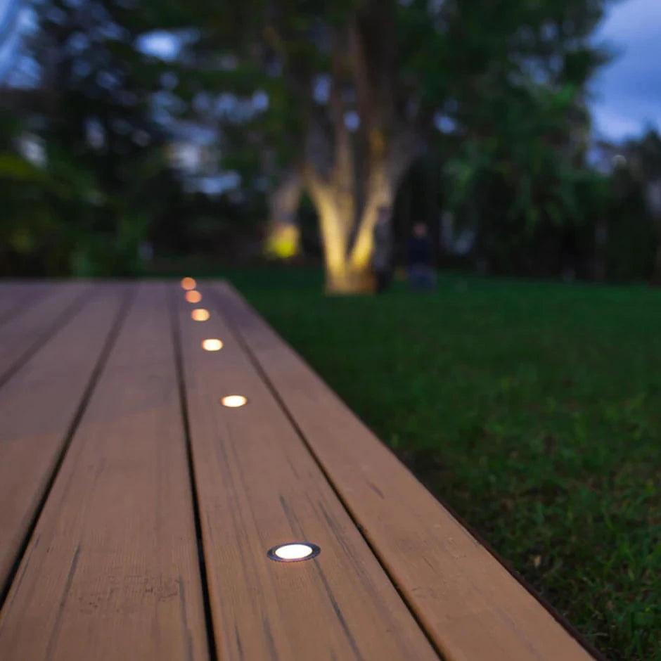 recessed solar-powered round lights installed on a deck.