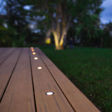 recessed solar-powered round lights installed on a deck.