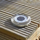 Wireless solar decking light on a deck.