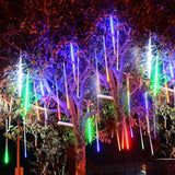 beautiful multicolor meteor shower lights wrapped around a tree in backyard